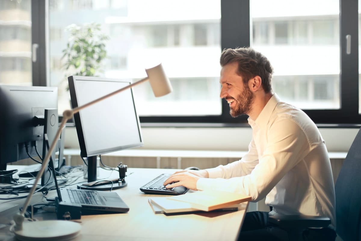 Man sitting in front of computer screens