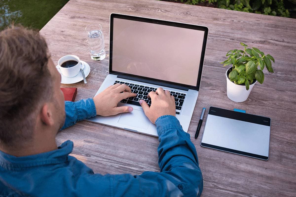 Man on laptop outside