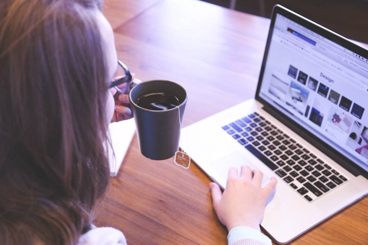 Woman on laptop with tea