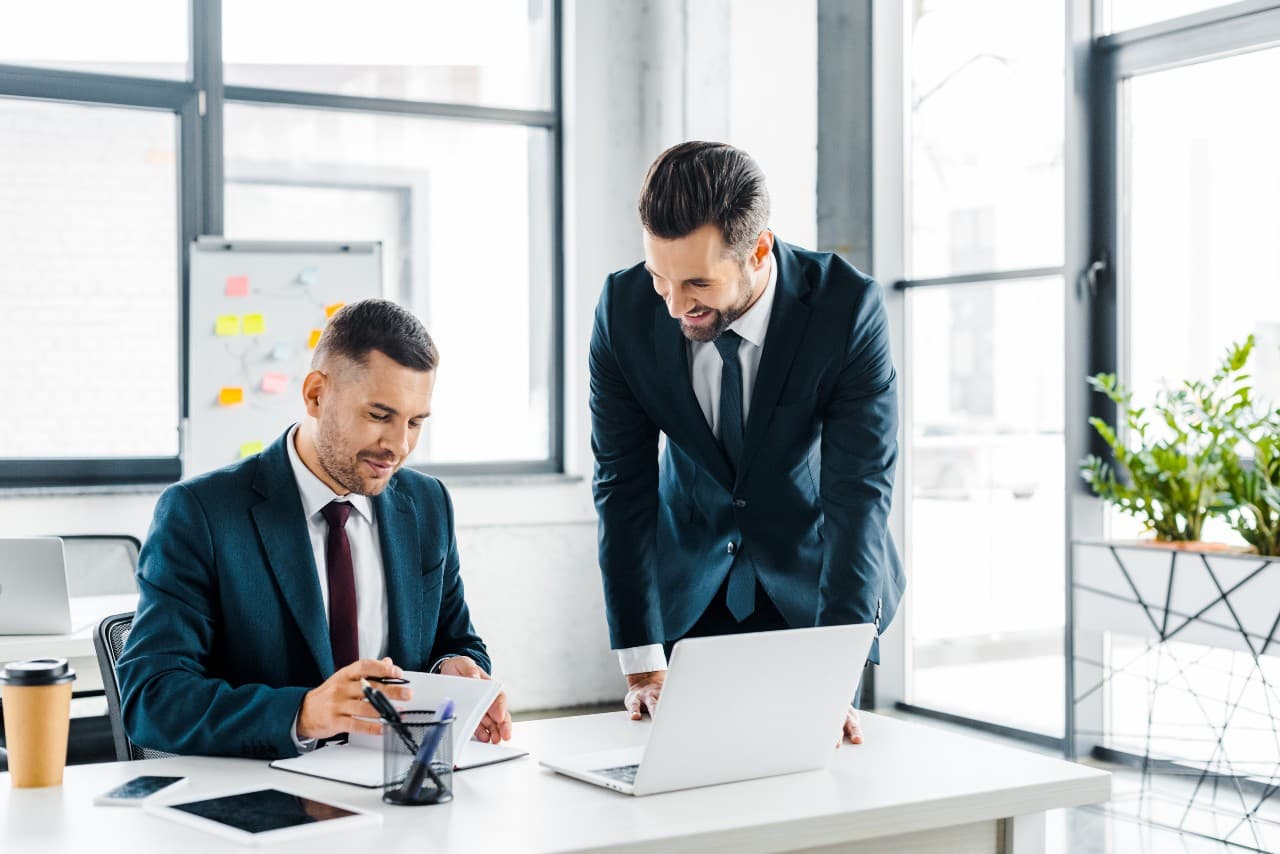 handsome businessman looking at coworker